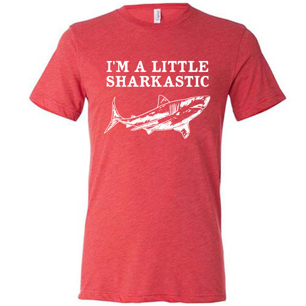 red unisex tee with the words "I'm a little sharkastic" on it, over the graphic of a shark