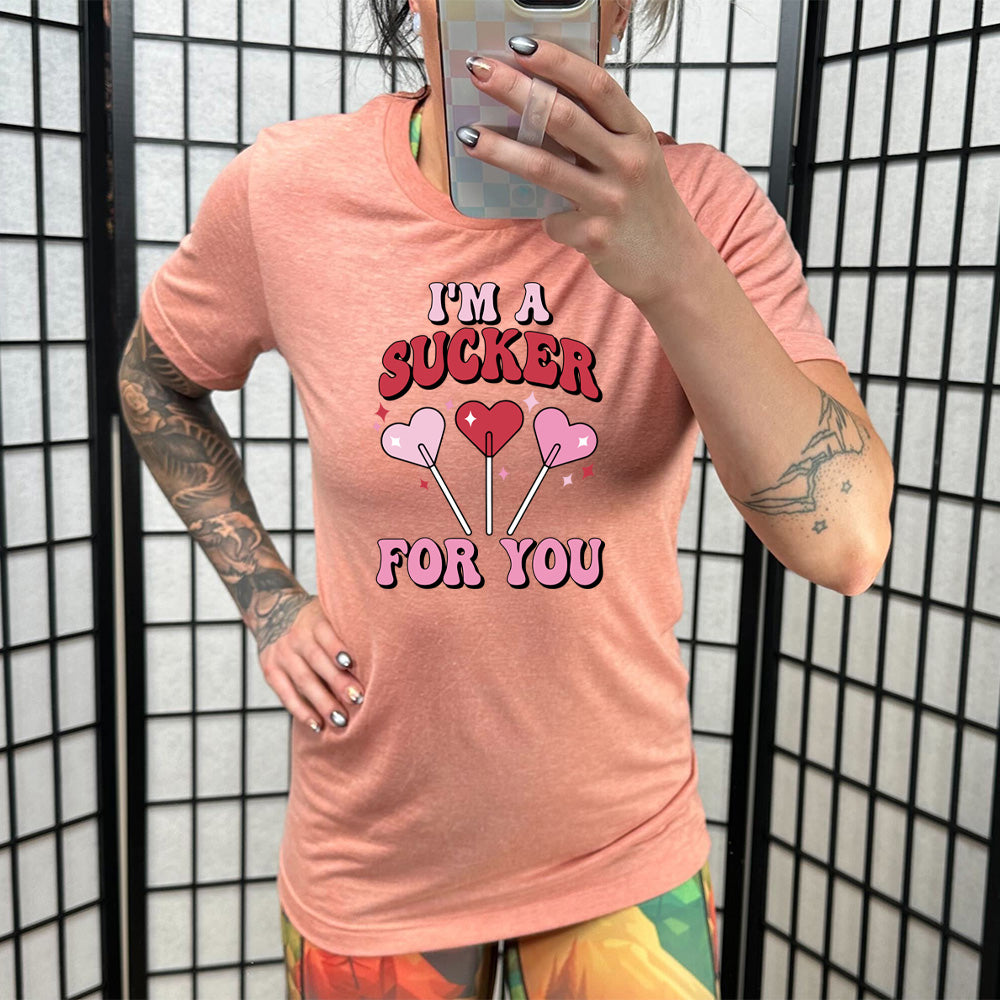 coral shirt with the text "I'm A Sucker For You" on it