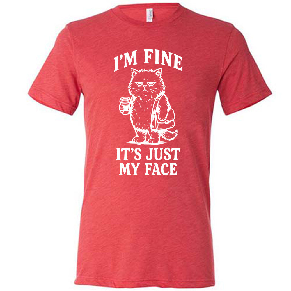 red unisex tee with the words "I'm fine it's just my face" on it, around the graphic of a cat with a resting-grumpy face, holding a coffee and wearing a purse
