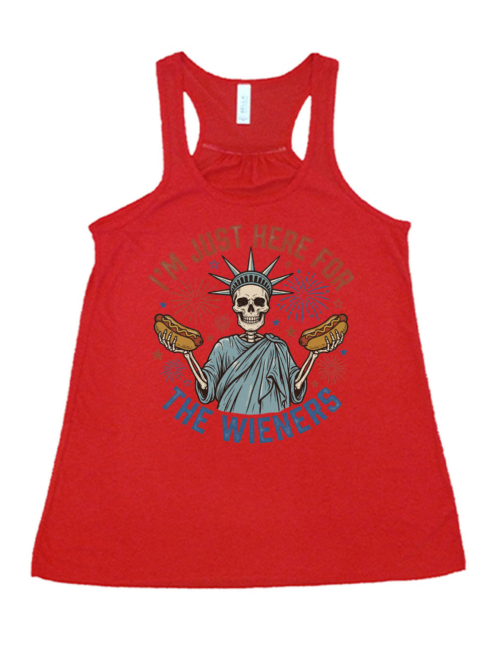 red flowy racerback tank with the words "I'm just here for the wieners" on it, with the graphic in the middle of the words of a skeletal statue of liberty with a hotdog in each hand and fireworks and stars around it
