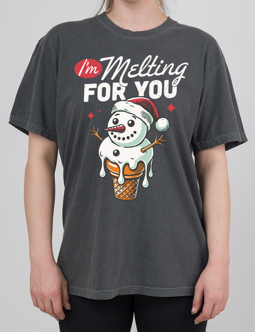 pepper modern tee with the graphic of a happy snowman's head and torso as the ice cream in a cone, dripping, wearing a Santa hat, with a couple stars, and the words above this saying "I'm Melting FOR YOU" with the "I'm" in a red oval