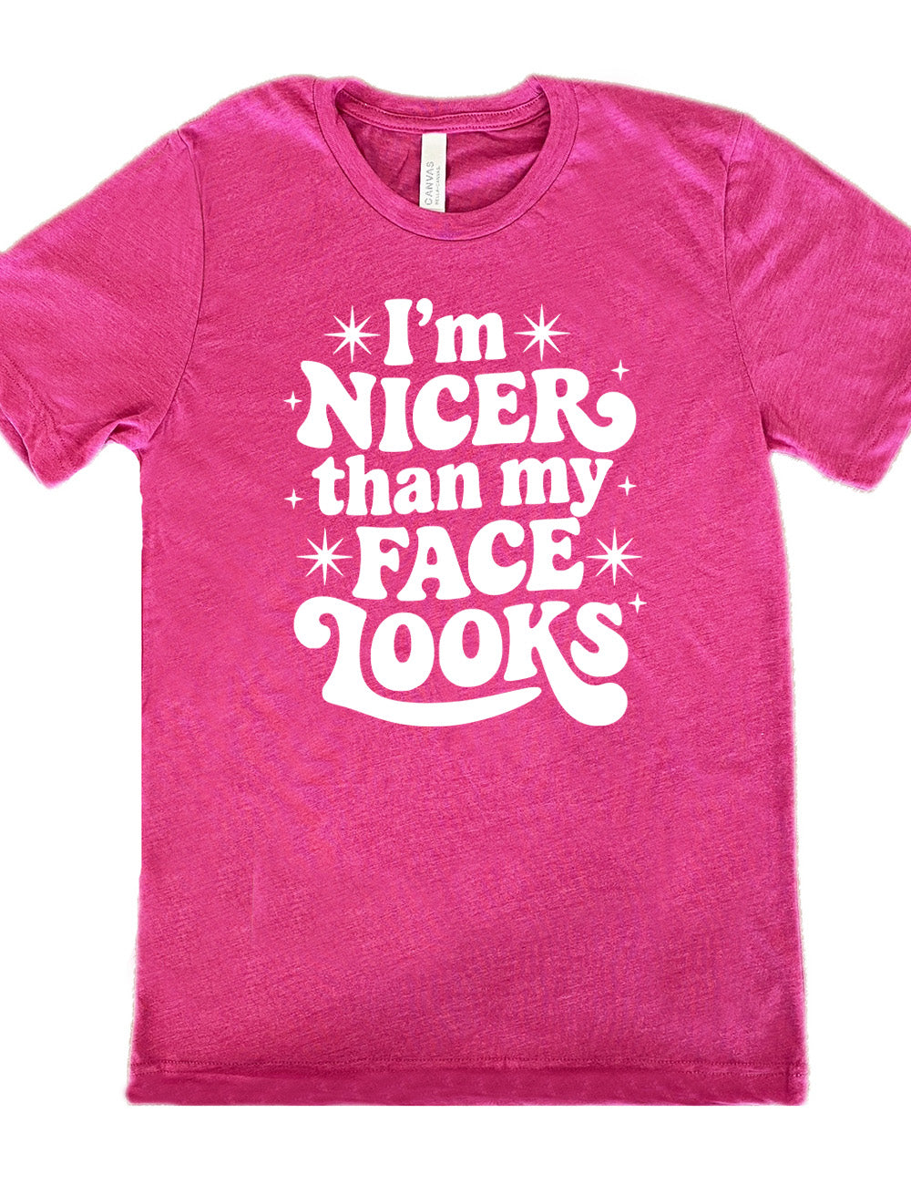 berry unisex tee with the words "I'm nicer than my face looks" surrounded by stars