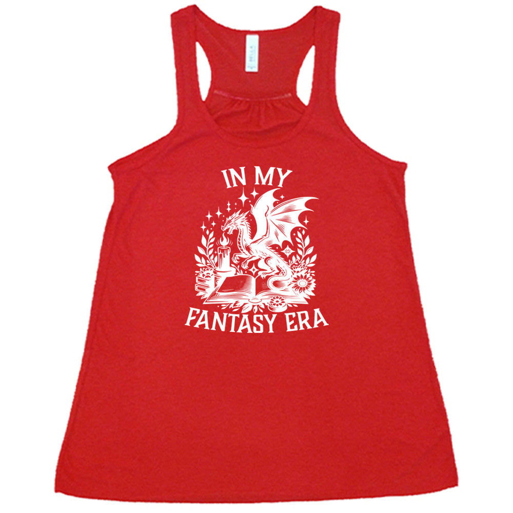 Red colored flowy tank with a dragon lighting a candle over a book graphic on it that says "In My Fantasy Era"