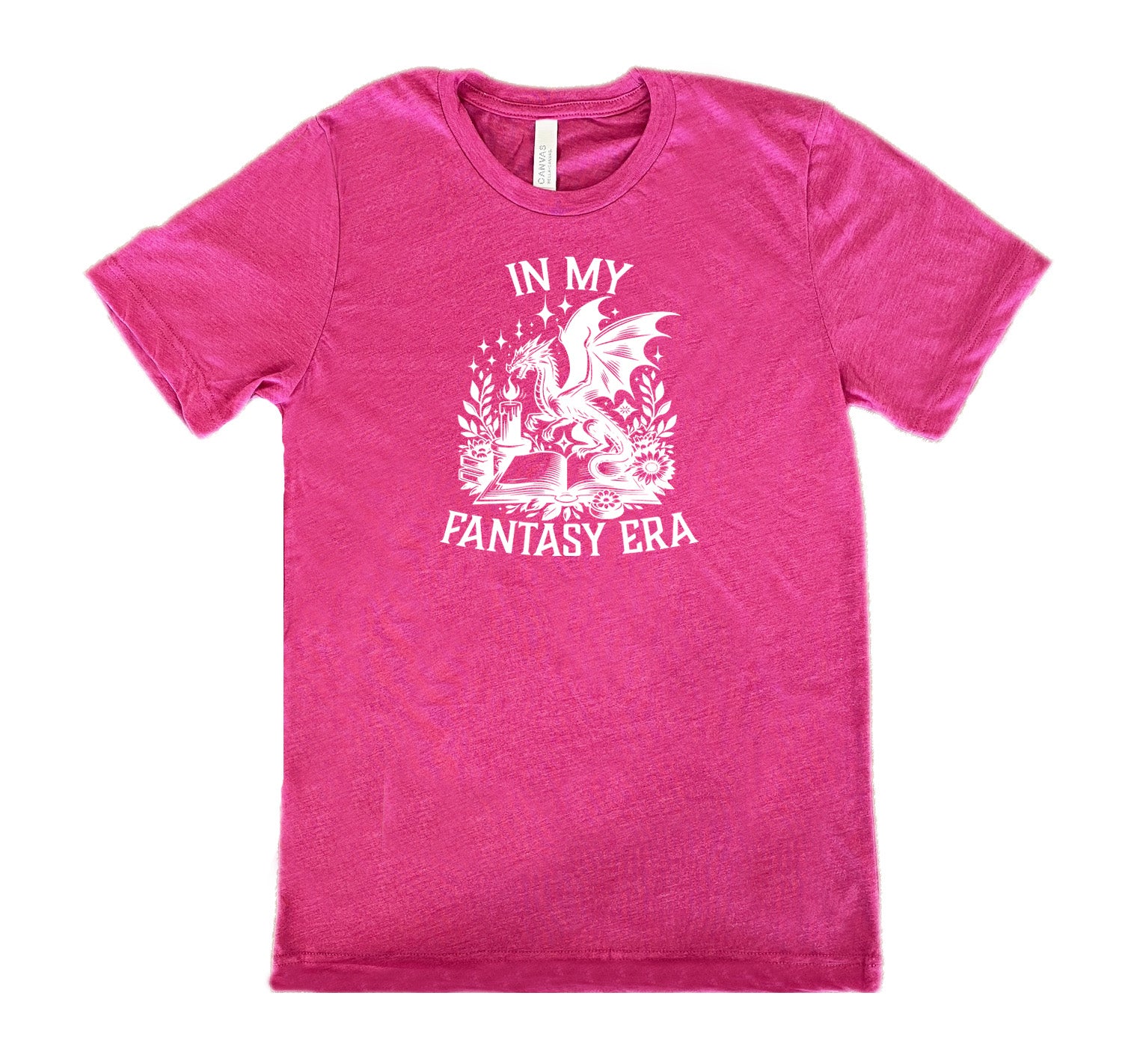 Berry colored shirt with a dragon lighting a candle over a book graphic on it that says "In My Fantasy Era"