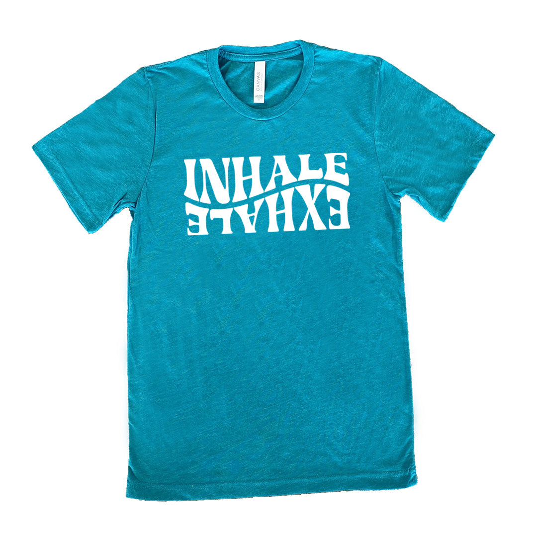 Teal unisex tee with the words "inhale exhale" on it, with the word "exhale" upside down and backwards, giving almost a yin and yang effect