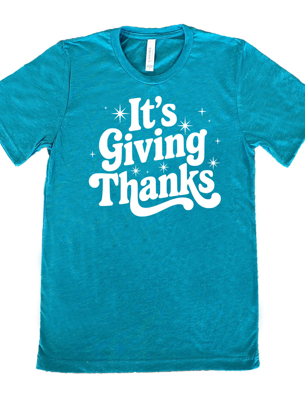 teal unisex tee with the words "It's Giving Thanks" on it, surrounded by graphics of little stars