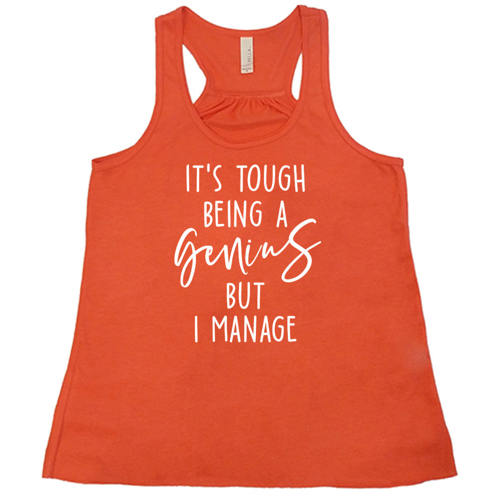 Coral colored flowy tank with graphic on it that says "It's Tough Being A Genius But I Manage"