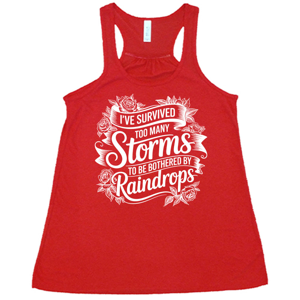 Red Flowy Tank, with wording I've Survived Too Many Storms to be Bothered by Raindrops, banners and flowers