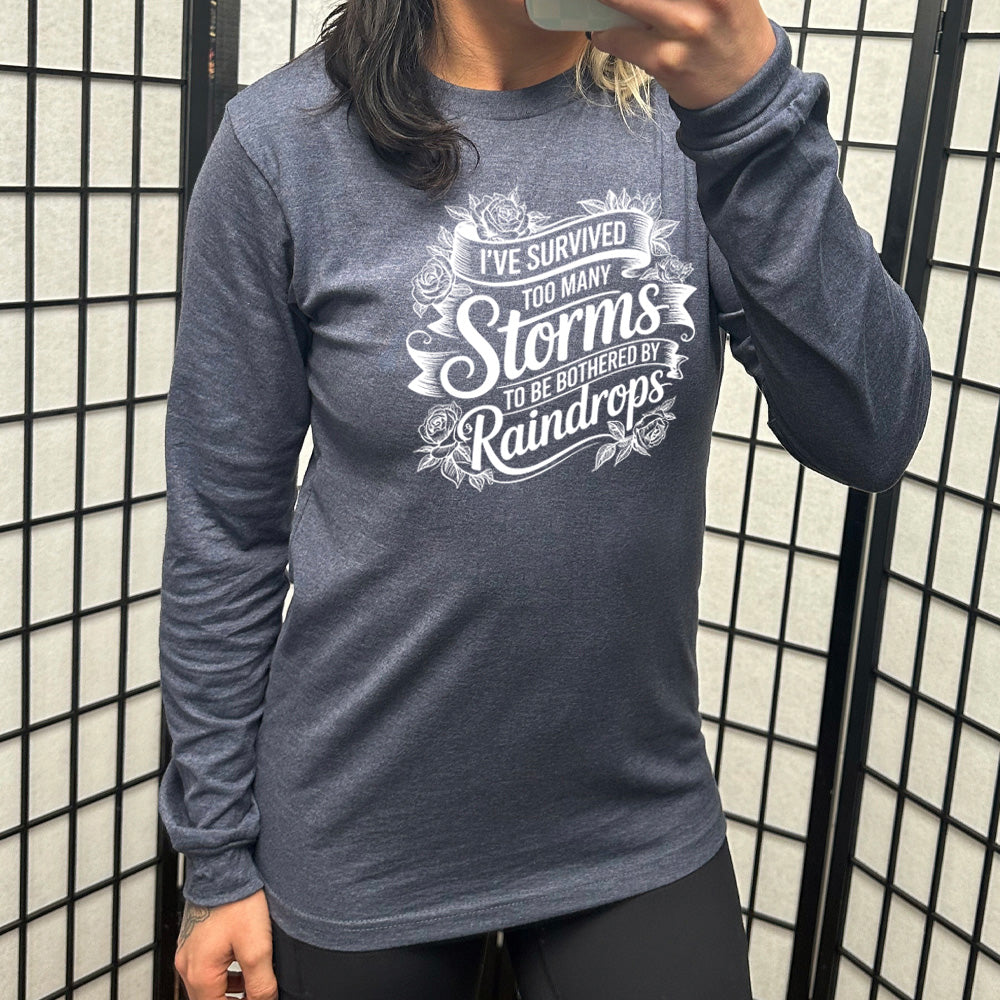 Heather Navy Long Sleeve, with wording I've Survived Too Many Storms to be Bothered by Raindrops, with banners and flowers