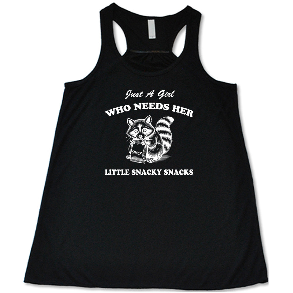 Black colored flowy tank with a raccoon holding a snack graphic on it that says "Just a Girl Who Needs Her Little Snacky Snacks"