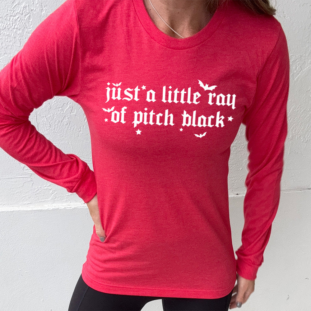 heather red long sleeve shirt with the words "just a little ray of pitch black" on it in a medieval font, with little bats and stars accenting the words