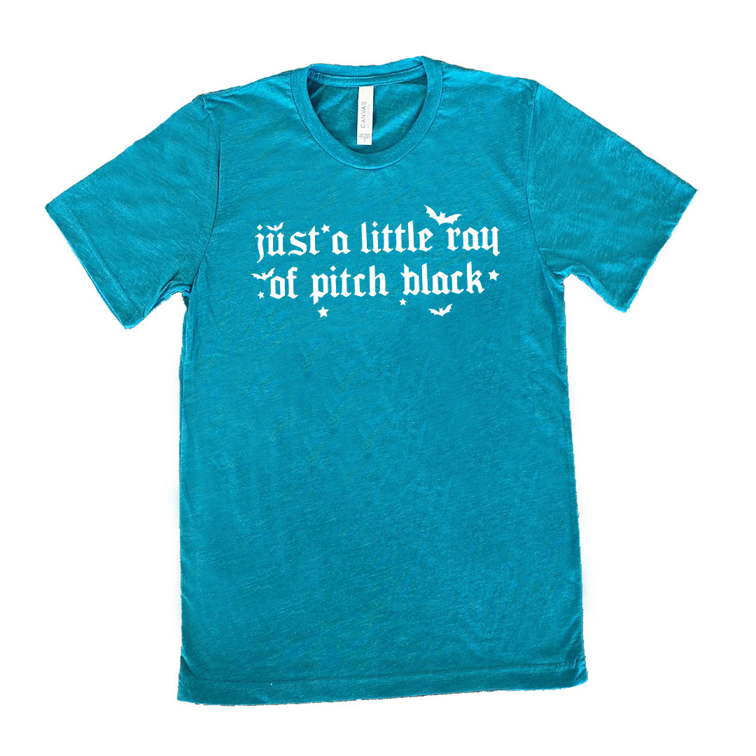 teal unisex tee with the words "just a little ray of pitch black" on it in a medieval font, with little bats and stars accenting the words