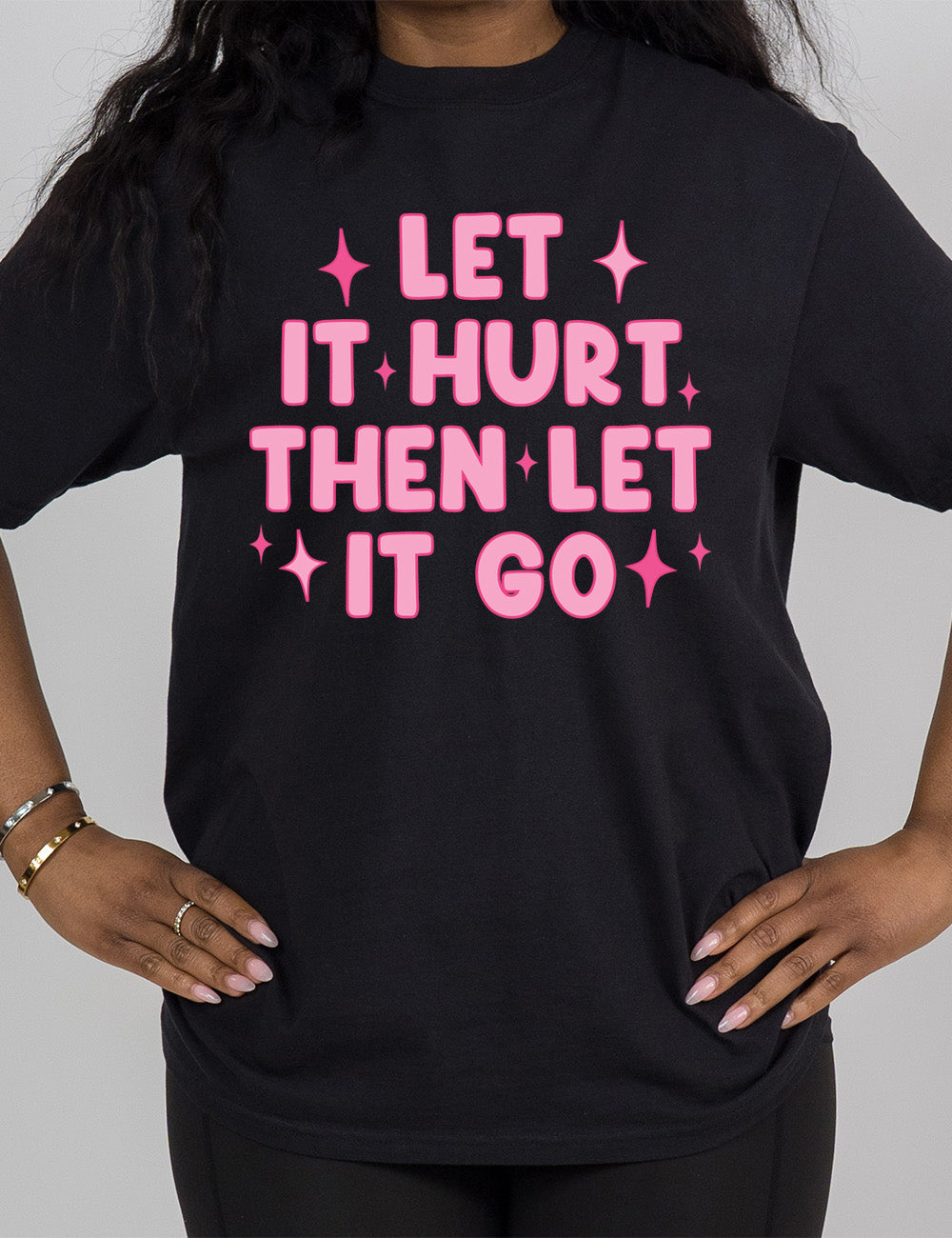 black modern tee with wording saying "let it hurt then let it go" with star graphics embellishing