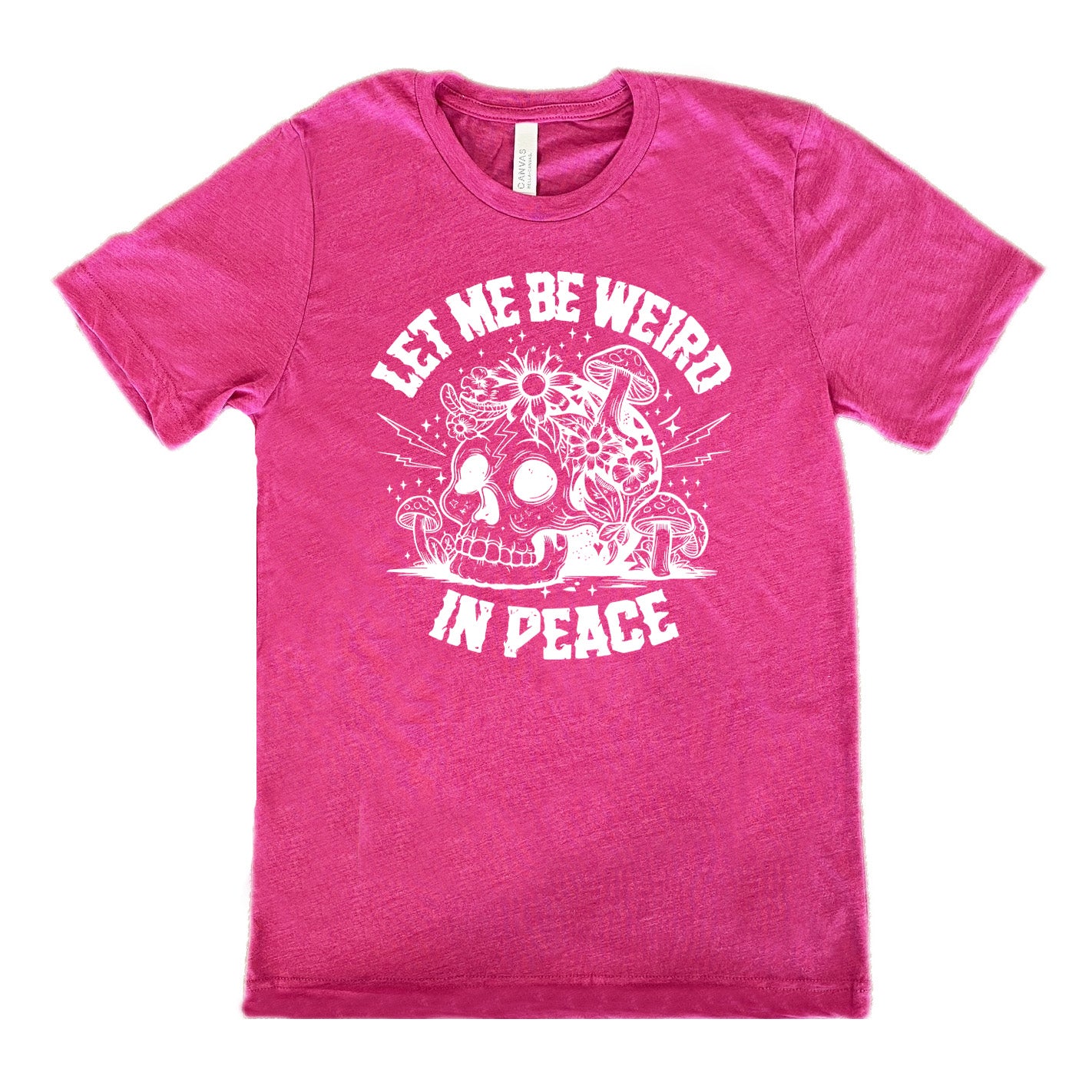 berry unisex tee with the words "let me be weird in peace" on it with the graphic of a skull on the ground with mushrooms growing on and around it, as well as flowers growing on it, surrounded by little stars and lightening bolts