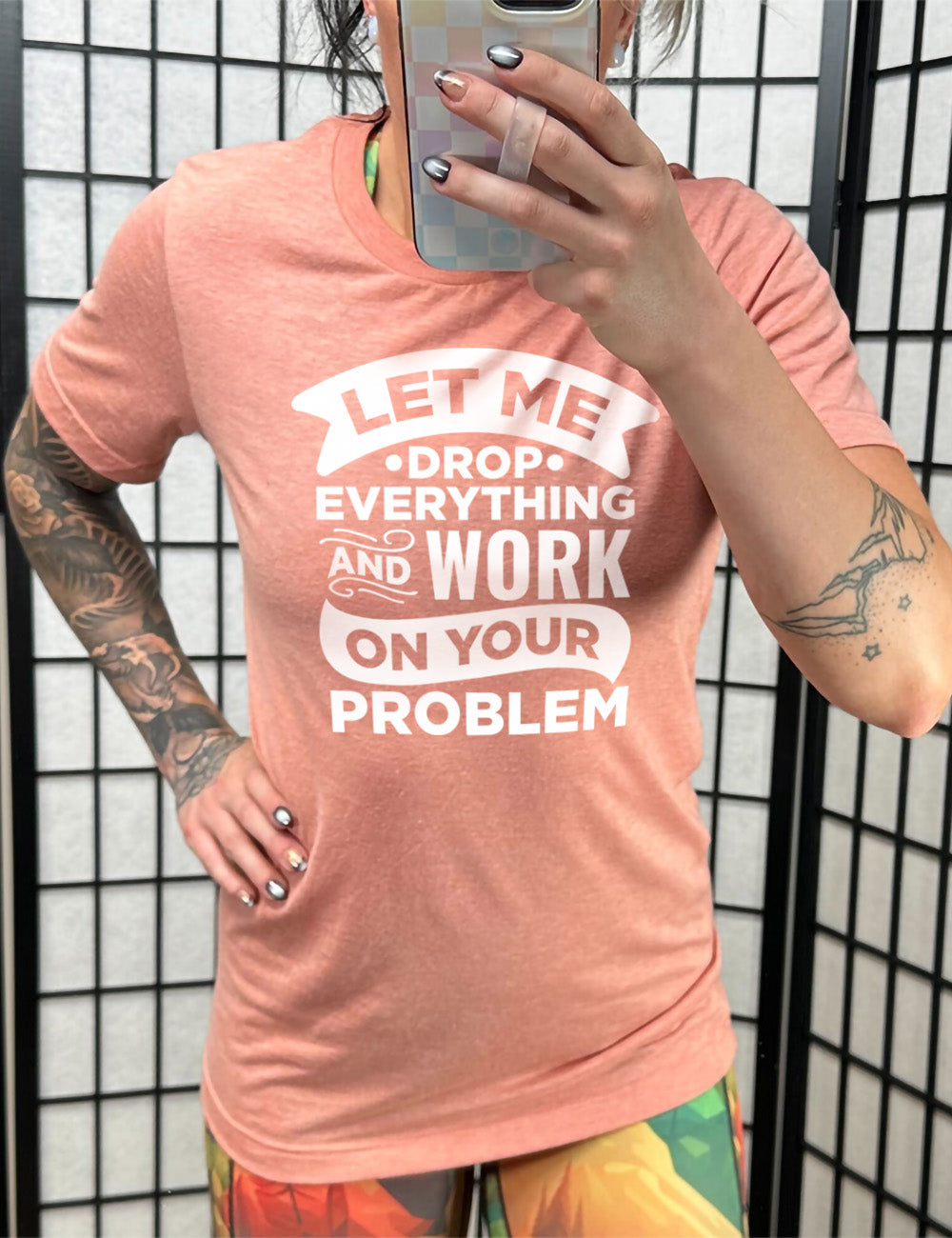 sunset unisex tee with the words, some of them bannered or embellished, saying "Let me drop everything and work on your problem"