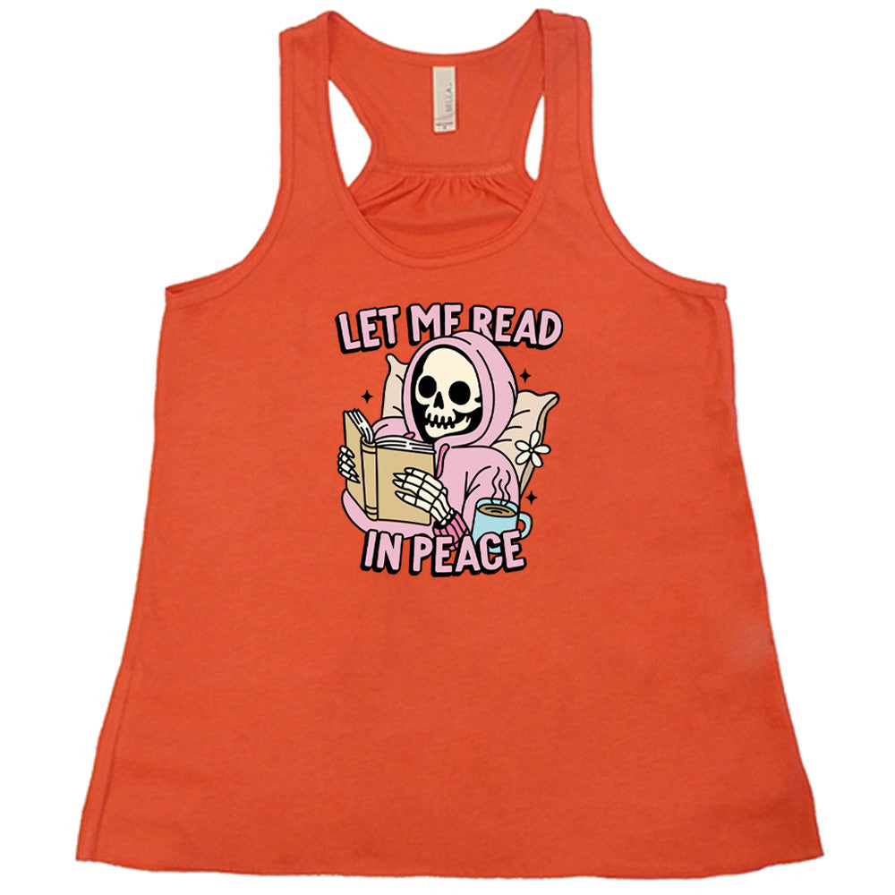 coral shirt with the text "Let Me Read In Peace" and a skeleton reading graphic on it