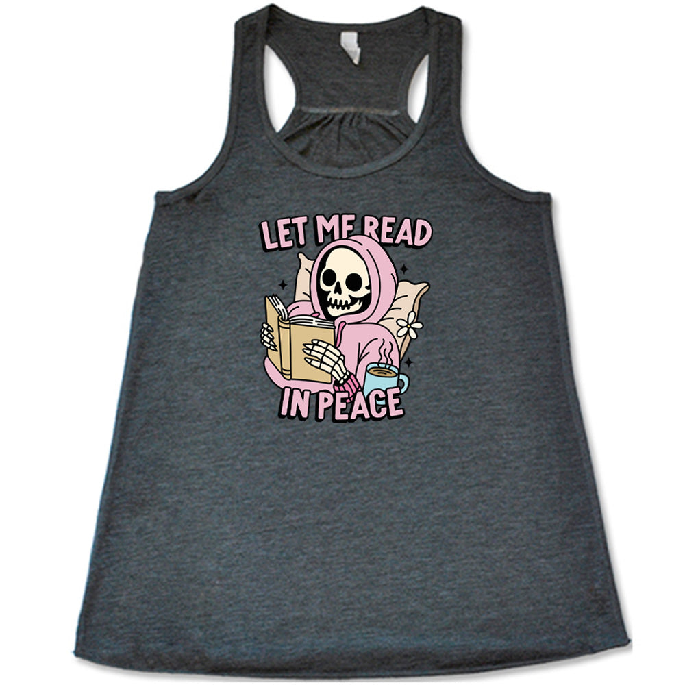 grey shirt with the text "Let Me Read In Peace" and a skeleton reading graphic on it