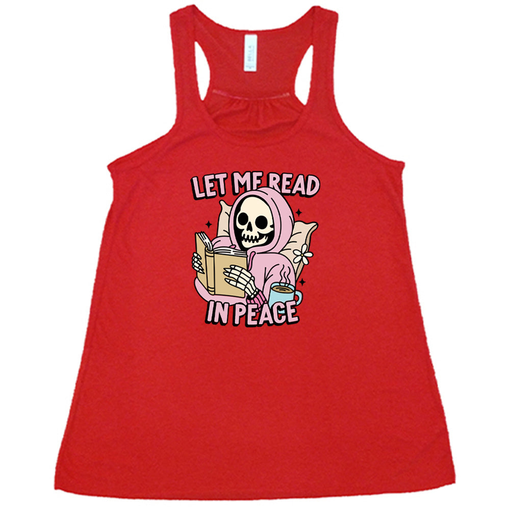 red shirt with the text "Let Me Read In Peace" and a skeleton reading graphic on it