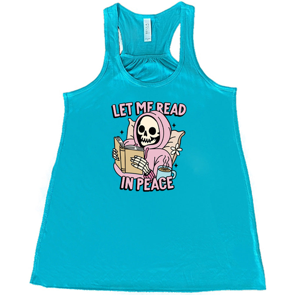 teal shirt with the text "Let Me Read In Peace" and a skeleton reading graphic on it