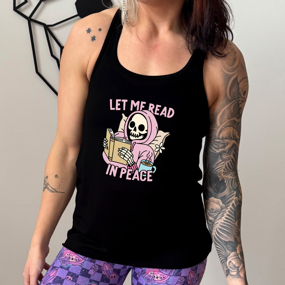 black shirt with the text "Let Me Read In Peace" and a skeleton reading graphic on it