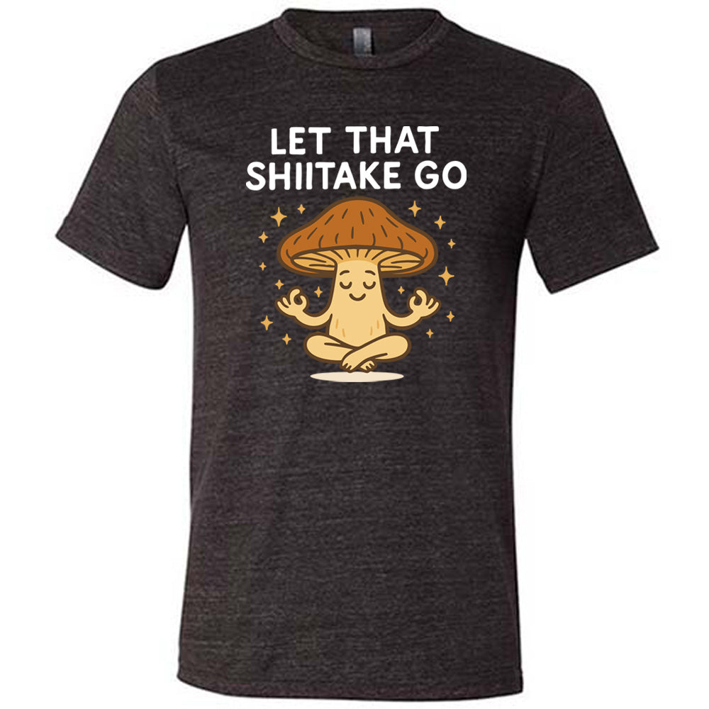 black unisex tee with the words "let that shiitake go" on it and the graphic of a mushroom doing a yoga pose, surrounded by little stars