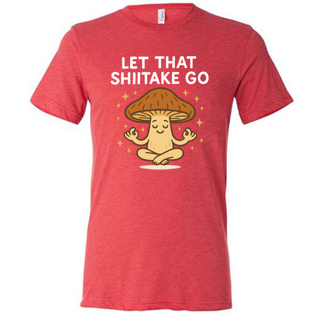 red unisex tee with the words "let that shiitake go" on it and the graphic of a mushroom doing a yoga pose, surrounded by little stars