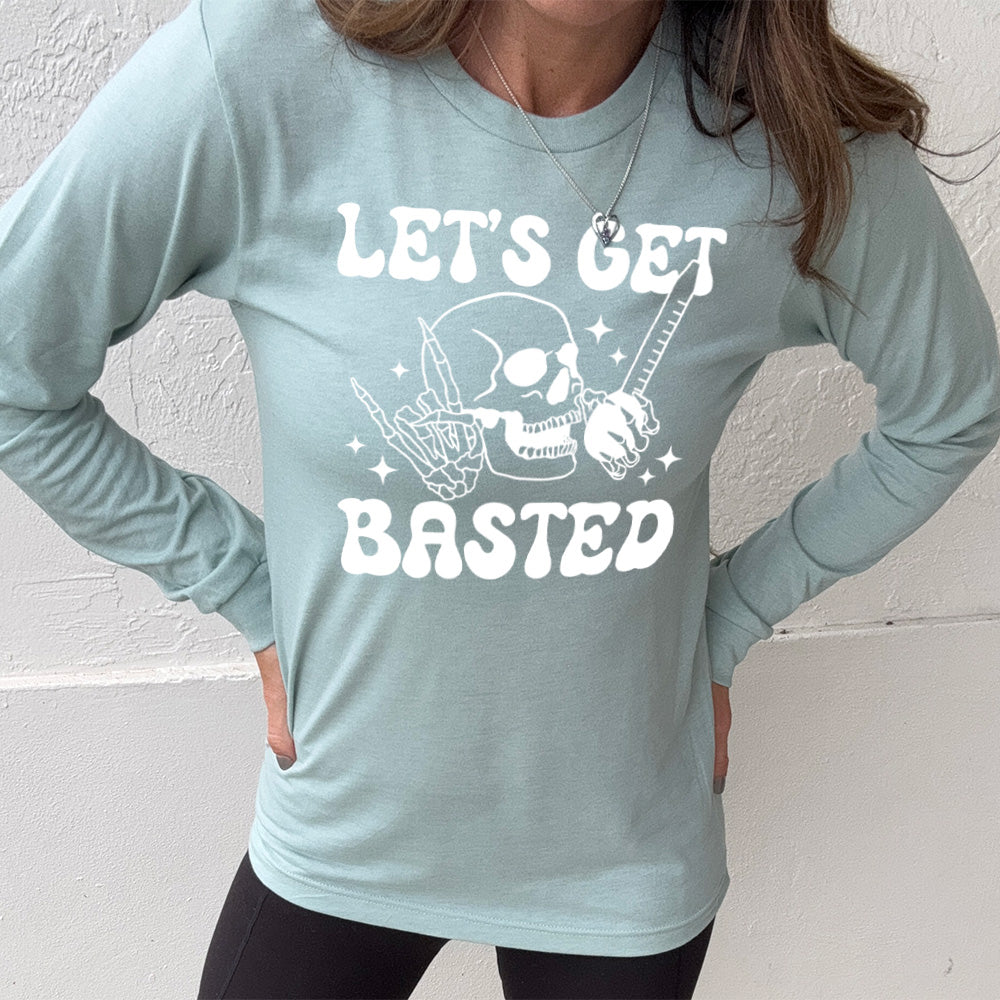 heather dusty blue long sleeve with the words "Let's get blasted" in white letter, with the image of a skull with a rocker hand and another hand holding a turkey baster