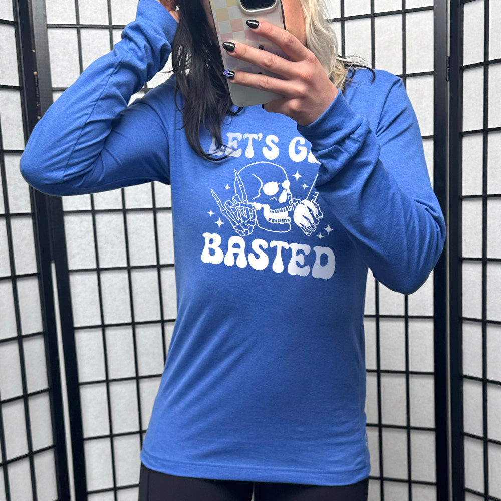 heather royal blue long sleeve with the words "Let's get blasted" in white letter, with the image of a skull with a rocker hand and another hand holding a turkey baster