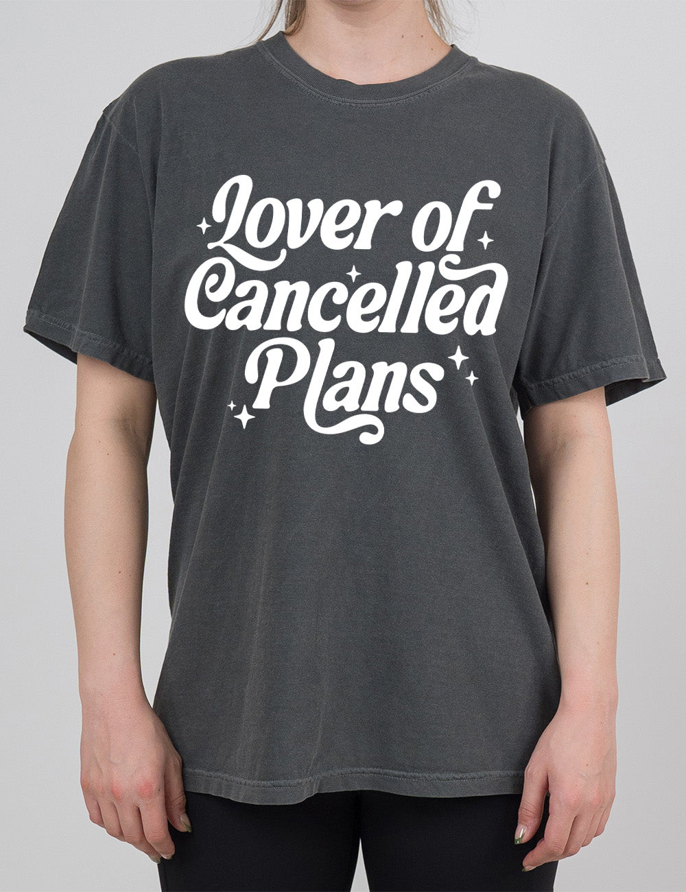 pepper modern tee with the words on it saying "lover of cancelled plans" with a few stars around the words