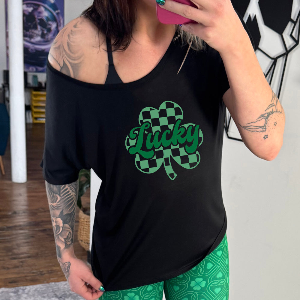 black slouchy shirt with a checkered shamrock graphic on it