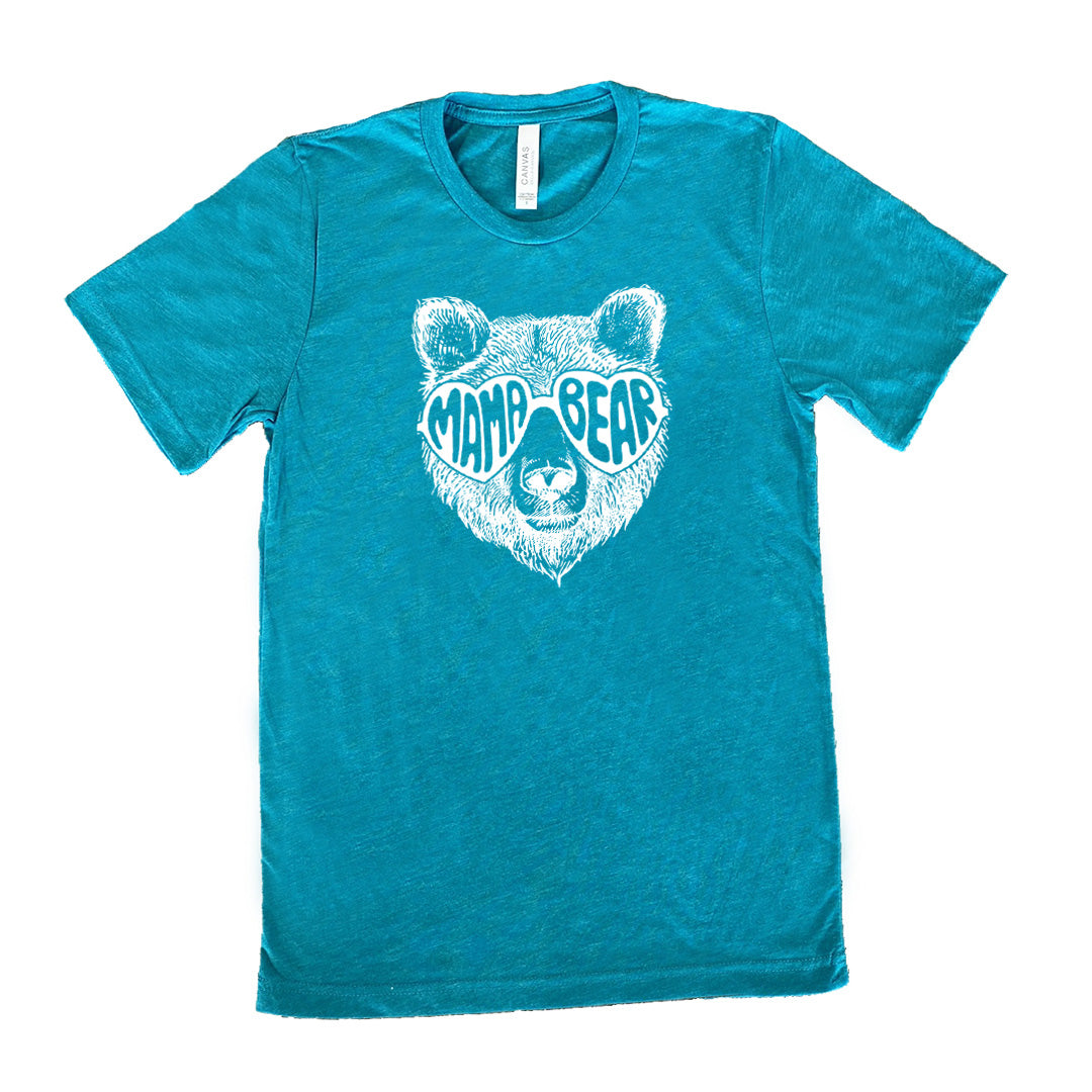 Teal colored shirt with a bear wearing heart-shaped glasses graphic on it that says "Mama Bear"