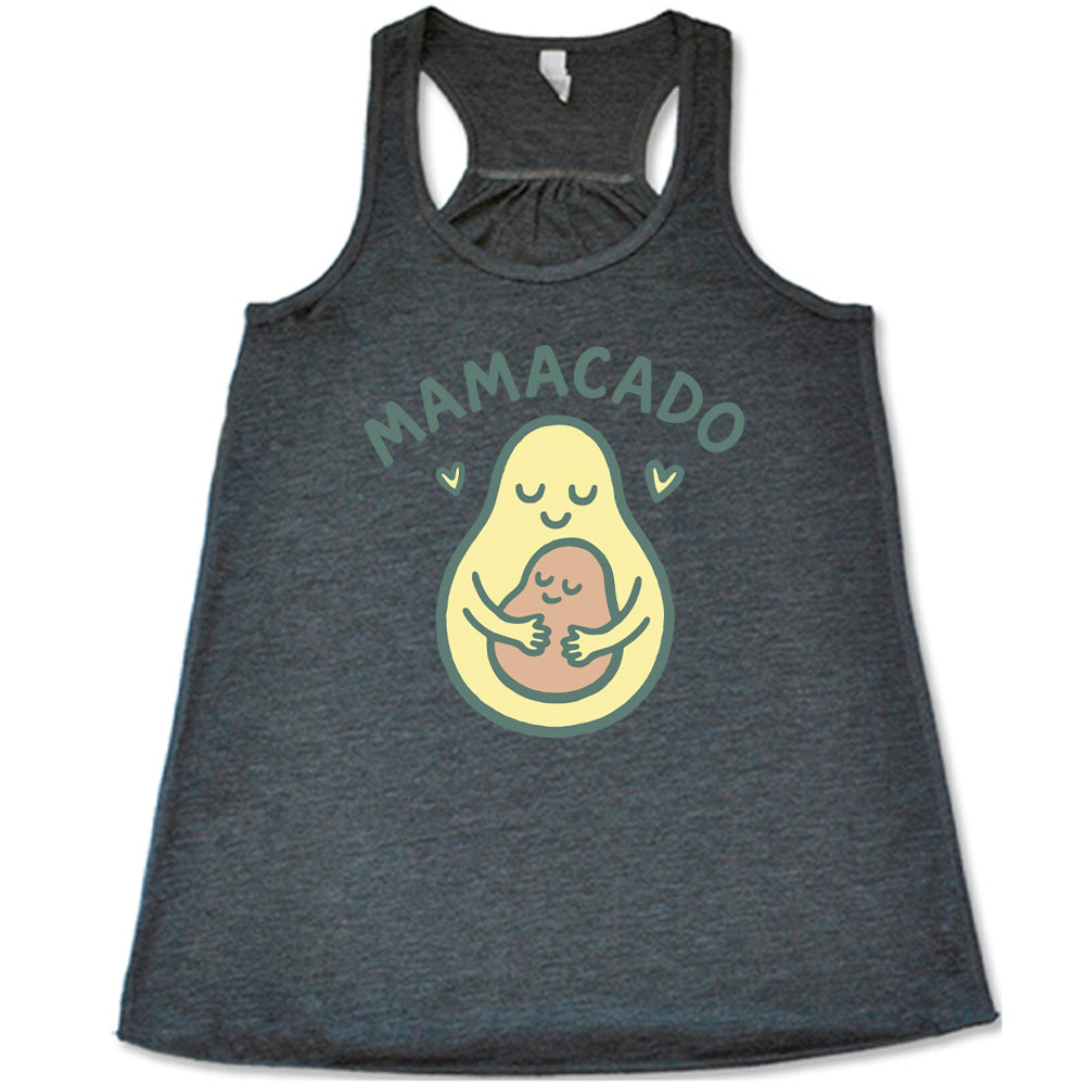 grey racerback flowy tank with the words "mamacado" on it, with the graphic of an avocado, peacefully smiling, with arms, holding her smiling baby (the color and placement of the avocado pit - but in the shape of an avocado), with a little heart on either side