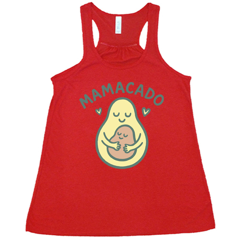 red racerback flowy tank with the words "mamacado" on it, with the graphic of an avocado, peacefully smiling, with arms, holding her smiling baby (the color and placement of the avocado pit - but in the shape of an avocado), with a little heart on either side