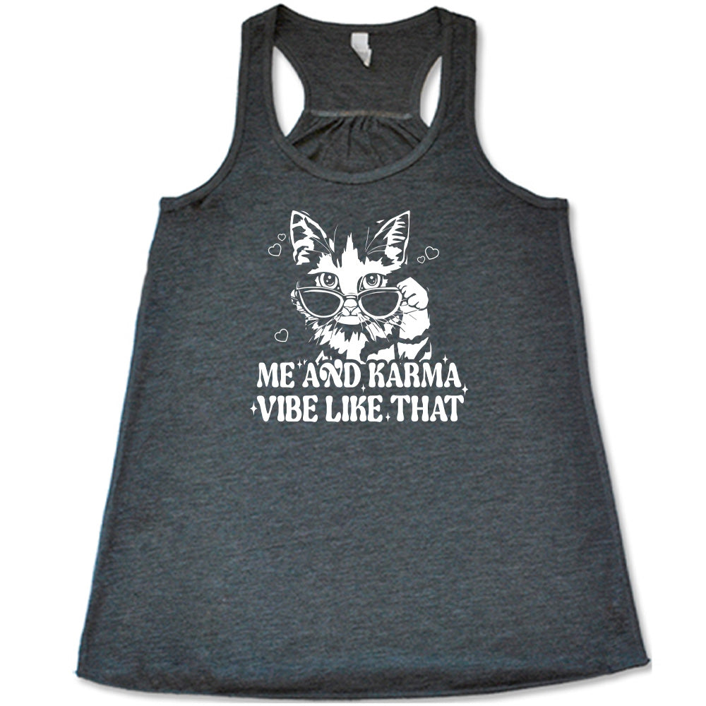 Grey colored flowy tank with a cat wearing sunglasses graphic on it that says "Me and Karma Vibe Like That"