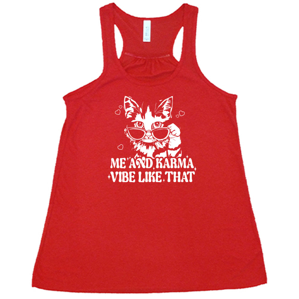Red colored flowy tank with a cat wearing sunglasses graphic on it that says "Me and Karma Vibe Like That"
