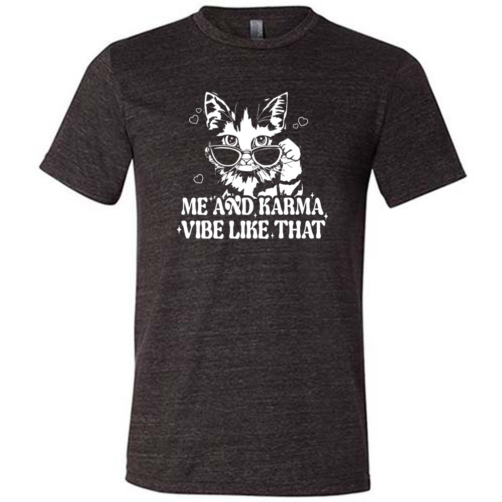Black colored shirt with a cat wearing sunglasses graphic on it that says "Me and Karma Vibe Like That"