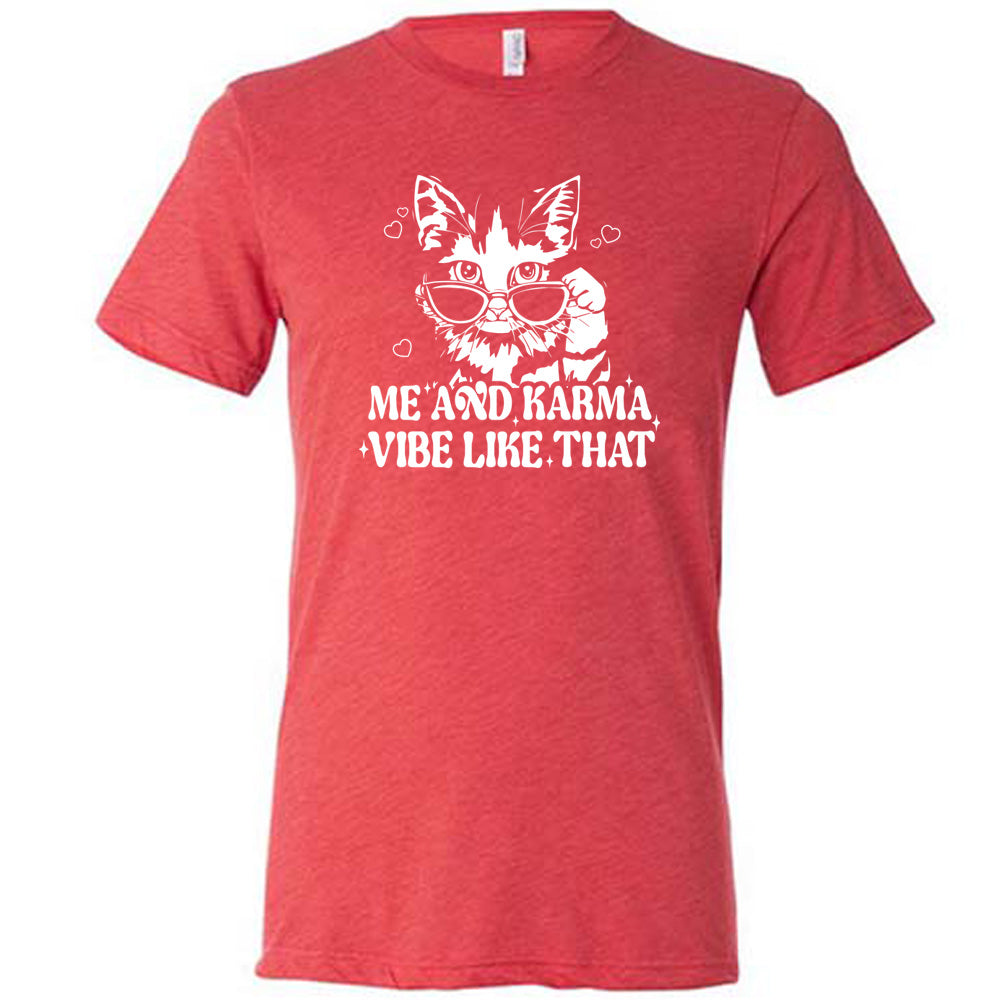 Red colored shirt with a cat wearing sunglasses graphic on it that says "Me and Karma Vibe Like That"
