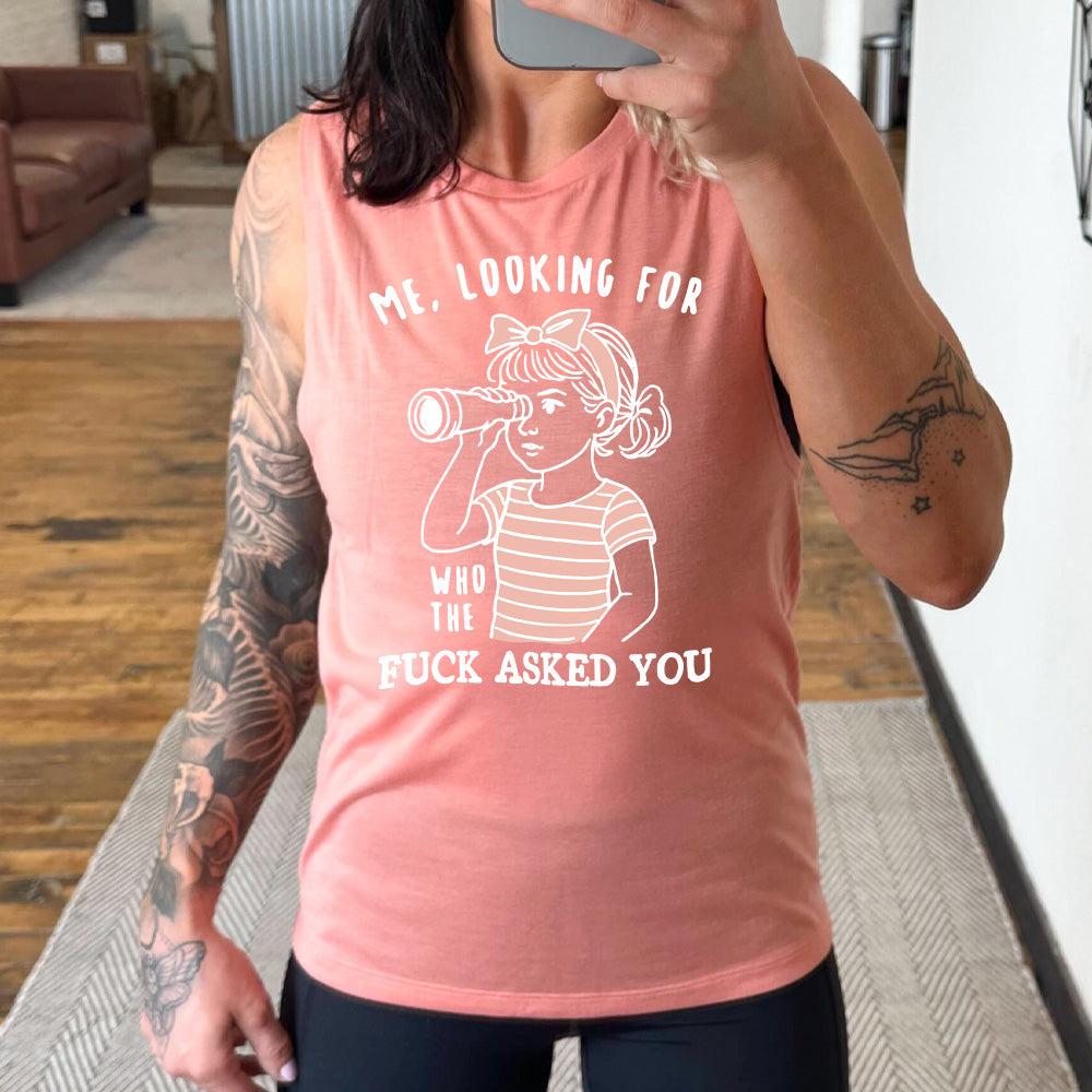 peach muscle tank with the graphic of a young girl, wearing a striped pink shirt and a pink bowed headband and looking through a telescope, and the words "me, looking for who the fuck asked you" on it