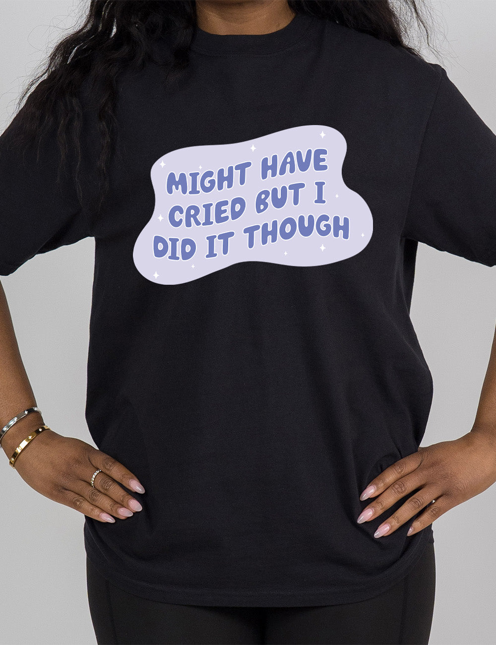 black modern tee with the words, within a blobby shape with a few stars, saying "might have cried but I did it though"