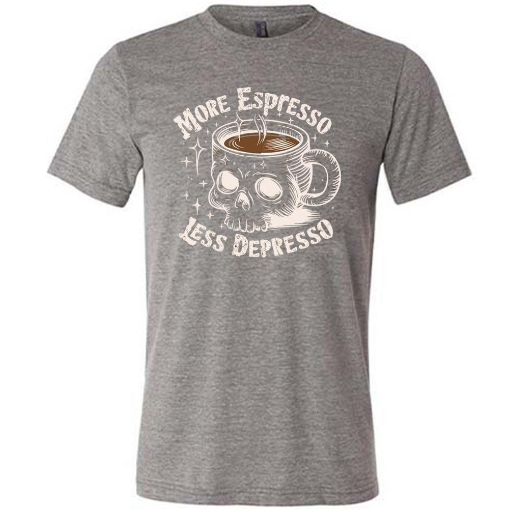 grey unisex tee with the words "more espresso less depresso on it, around the graphic of a skull-shaped mug full of a steaming beverage, with lots of little stars around