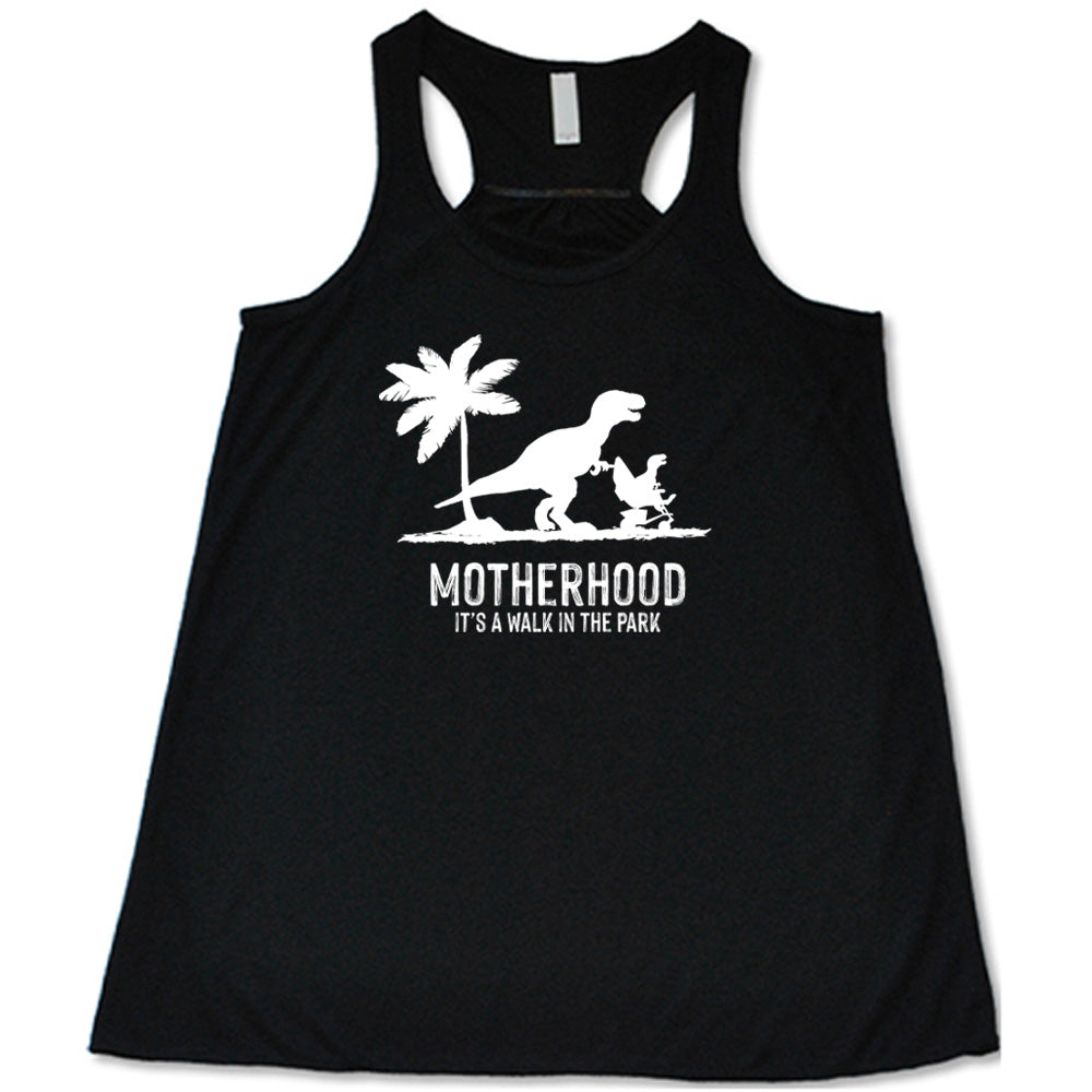 Black colored flowy tank with a mother and child dinosaur graphic on it that says "Motherhood, Its a Walk in the Park"