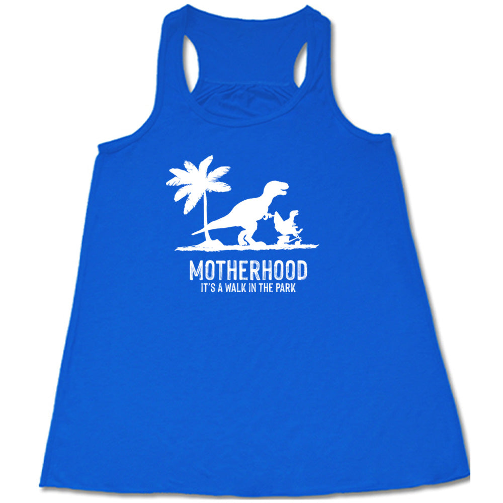 Blue colored flowy tank with a mother and child dinosaur graphic on it that says "Motherhood, Its a Walk in the Park"