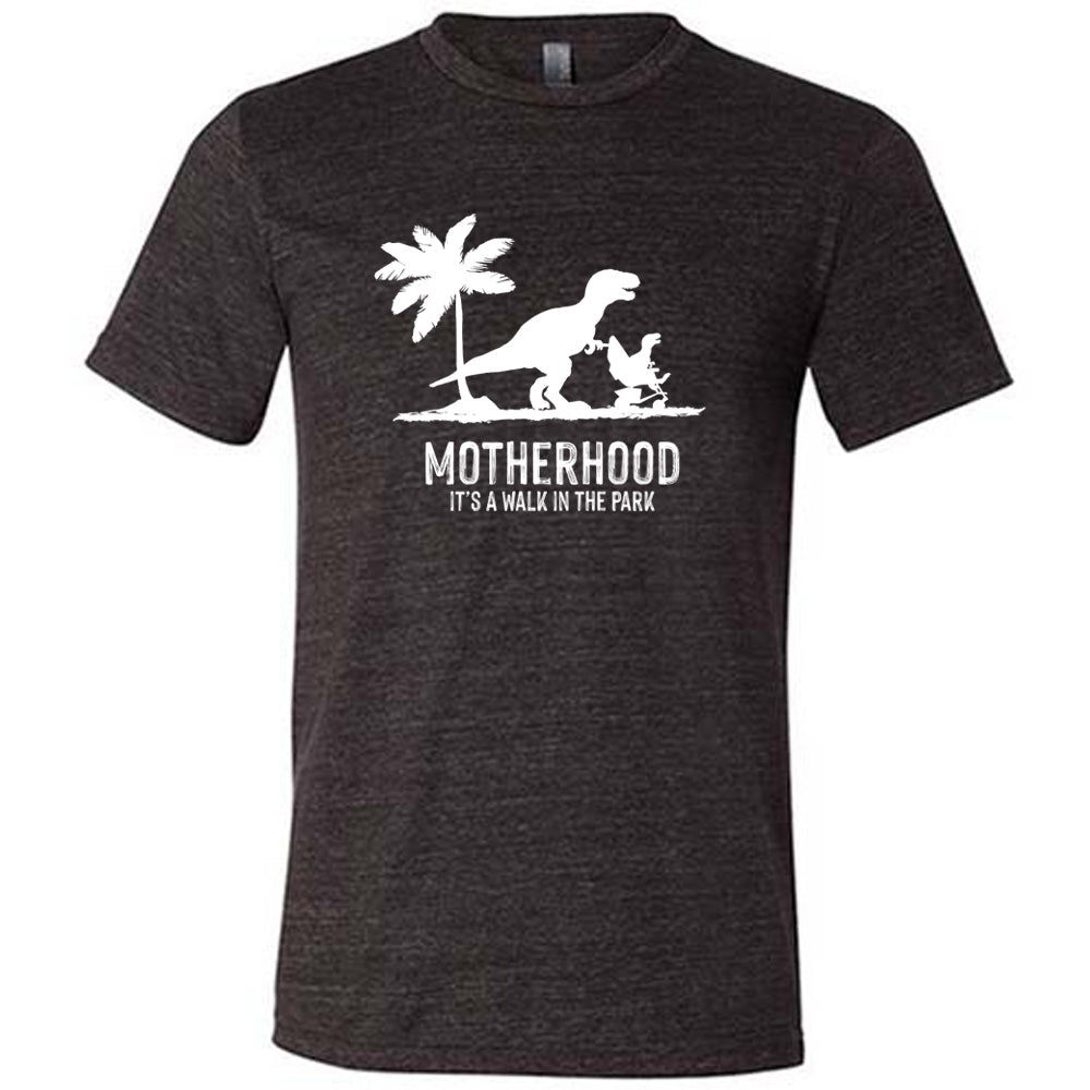 Black colored shirt with a mother and child dinosaur graphic on it that says "Motherhood, Its a Walk in the Park"
