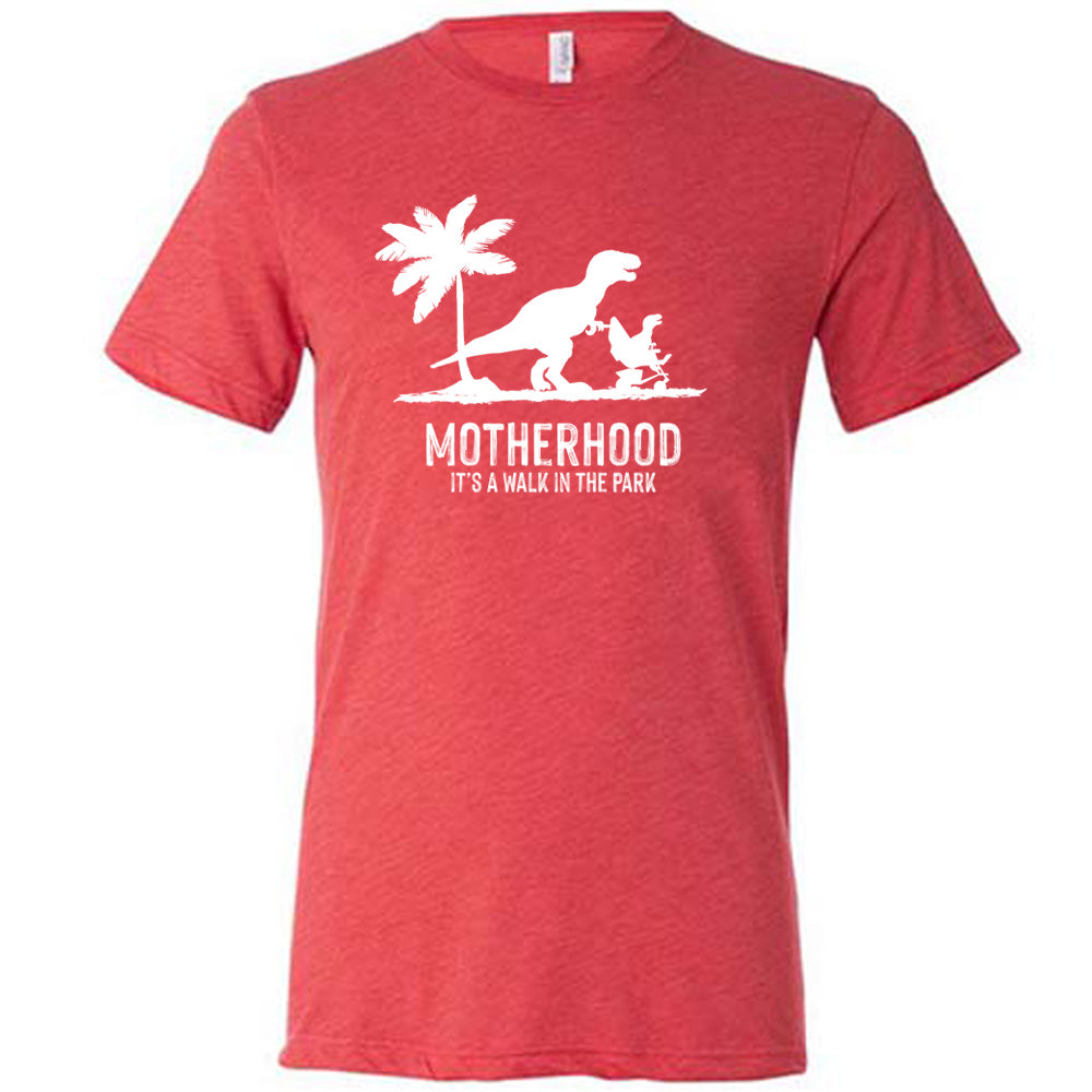 Red colored shirt with a mother and child dinosaur graphic on it that says "Motherhood, Its a Walk in the Park"