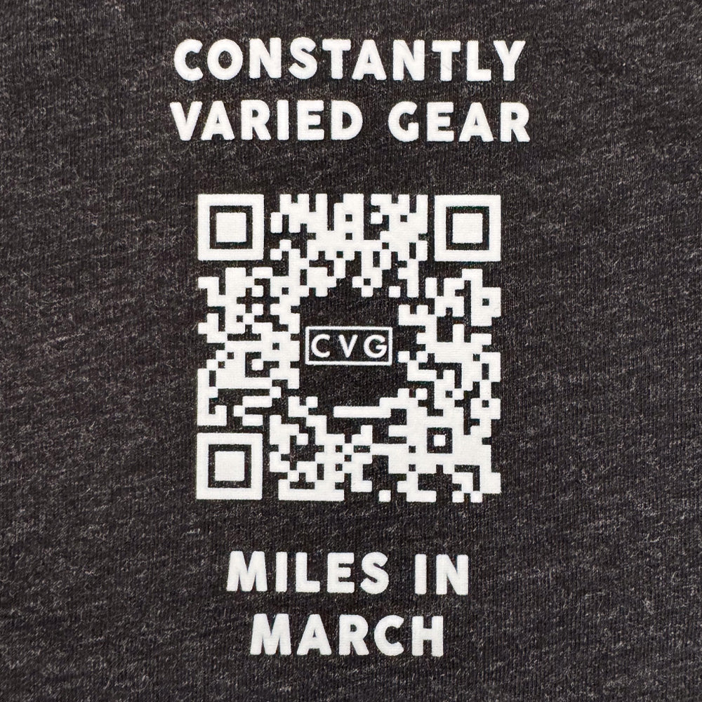 close up of the QR code on the back of the black shirt with the text "move for a mission" on it