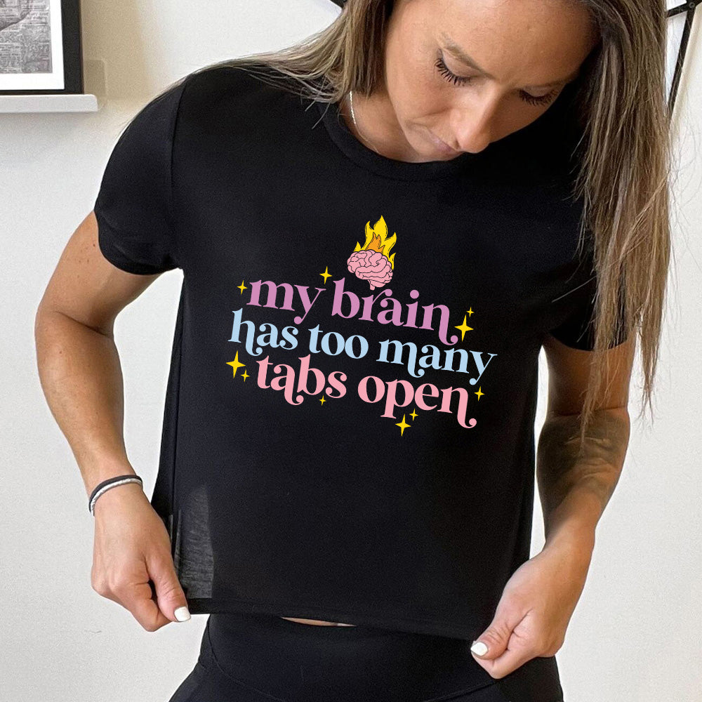 Black colored cropped tee with a flaming brain graphic on it that says "My Brain Has Too Many Tabs Open"