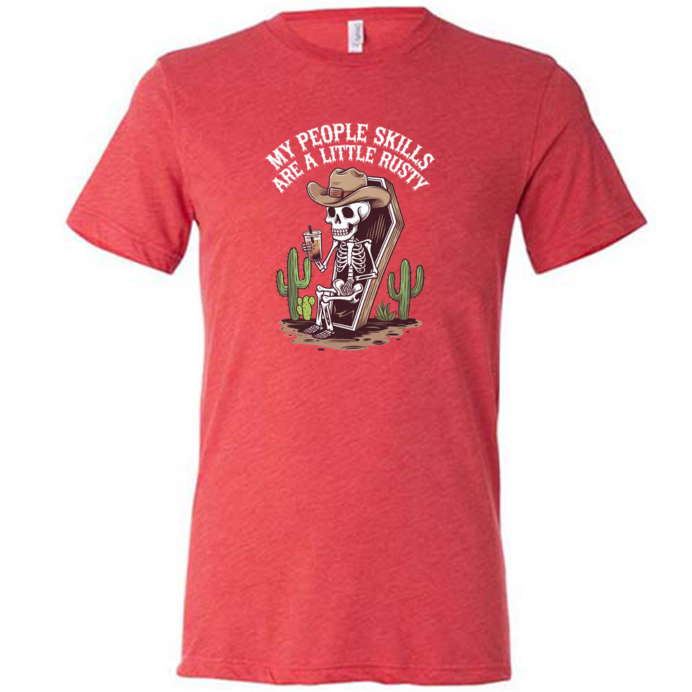 Red colored shirt with a skeleton sitting in a coffin graphic on it that says "My People Skills Are A Little Rusty"