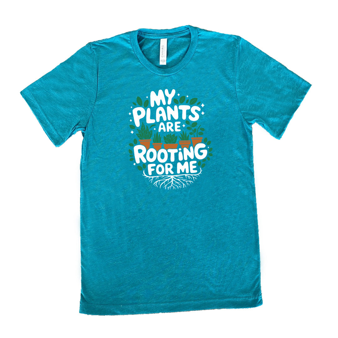 Teal colored shirt with a potted plants and roots graphic on it that says "My Plants Are Rooting For Me"