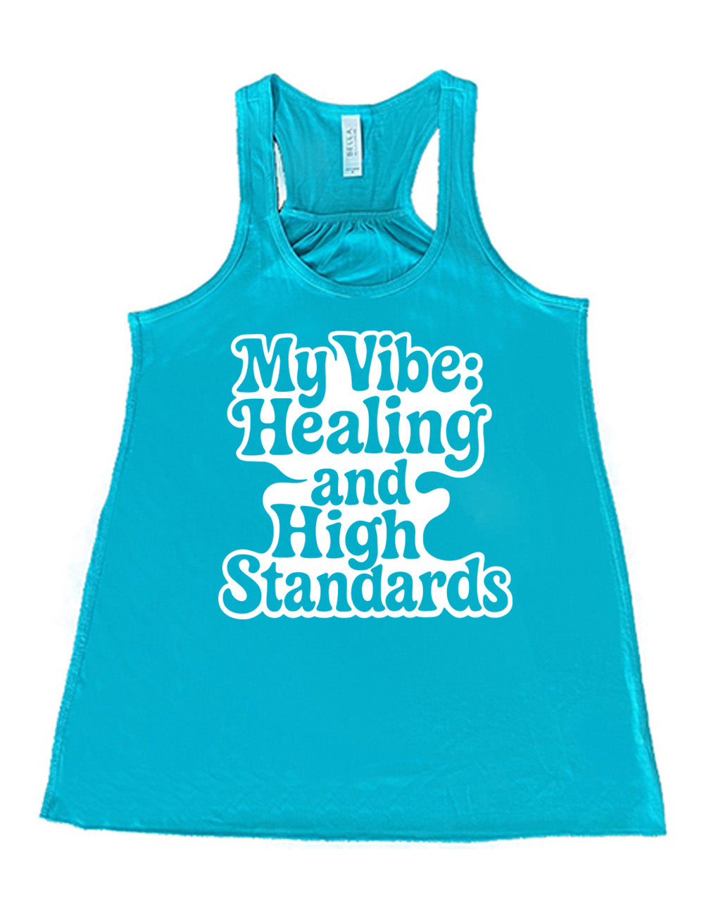 teal racerback flowy tank with the words "my vibe: healing and high standards" on it