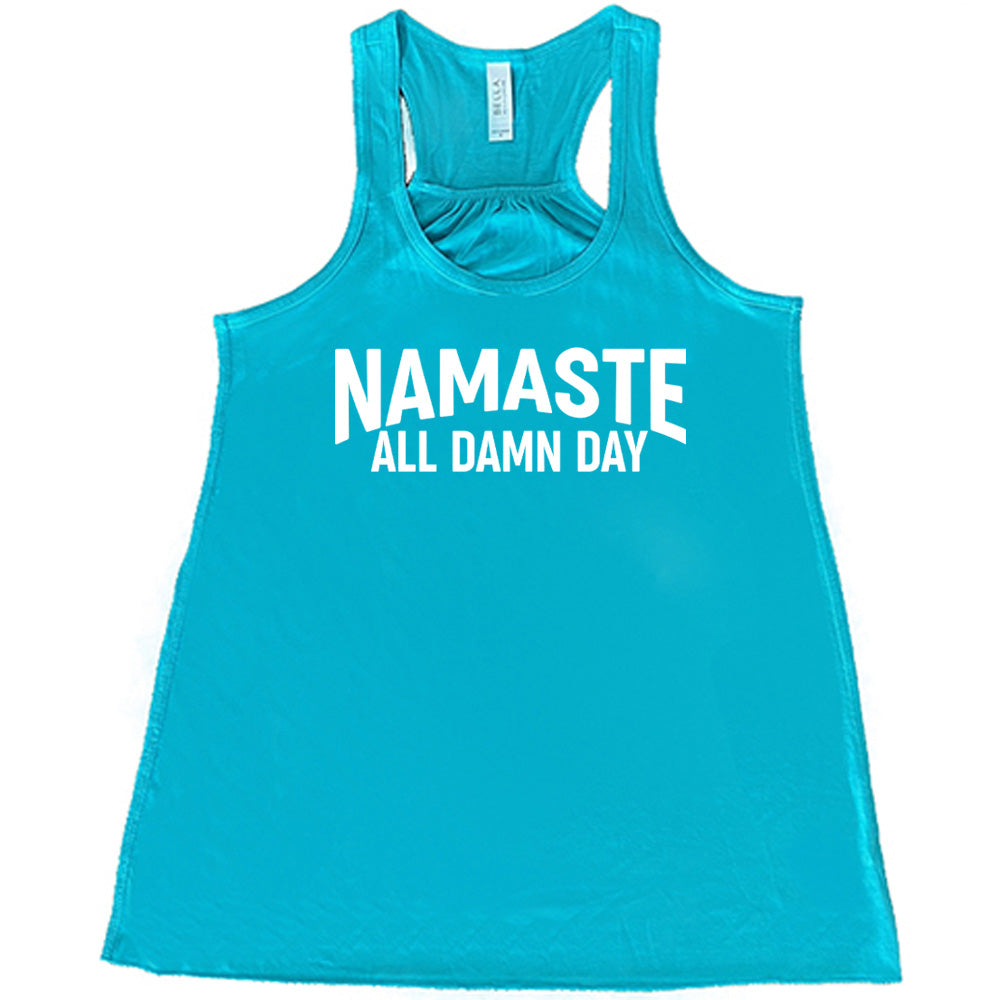 teal flowy tank with the words "Namaste all damn day" on it